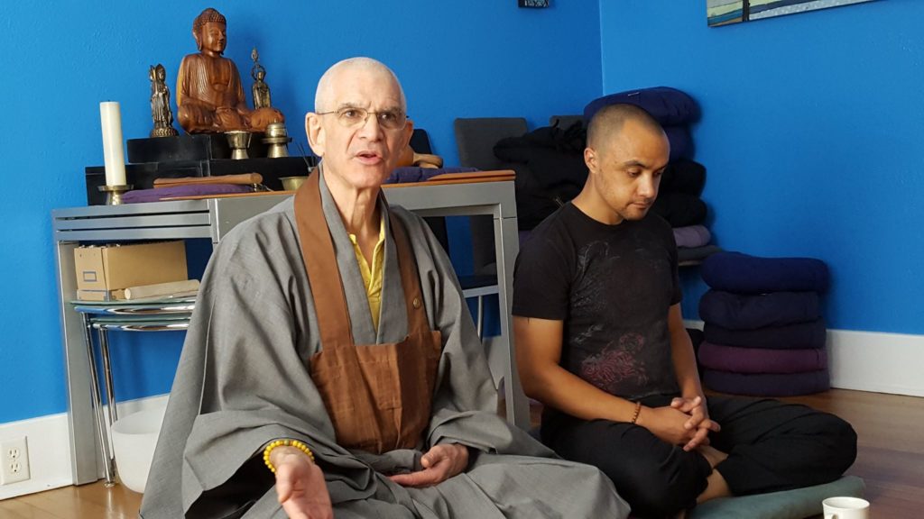 Zen teacher with one person sitting next to him